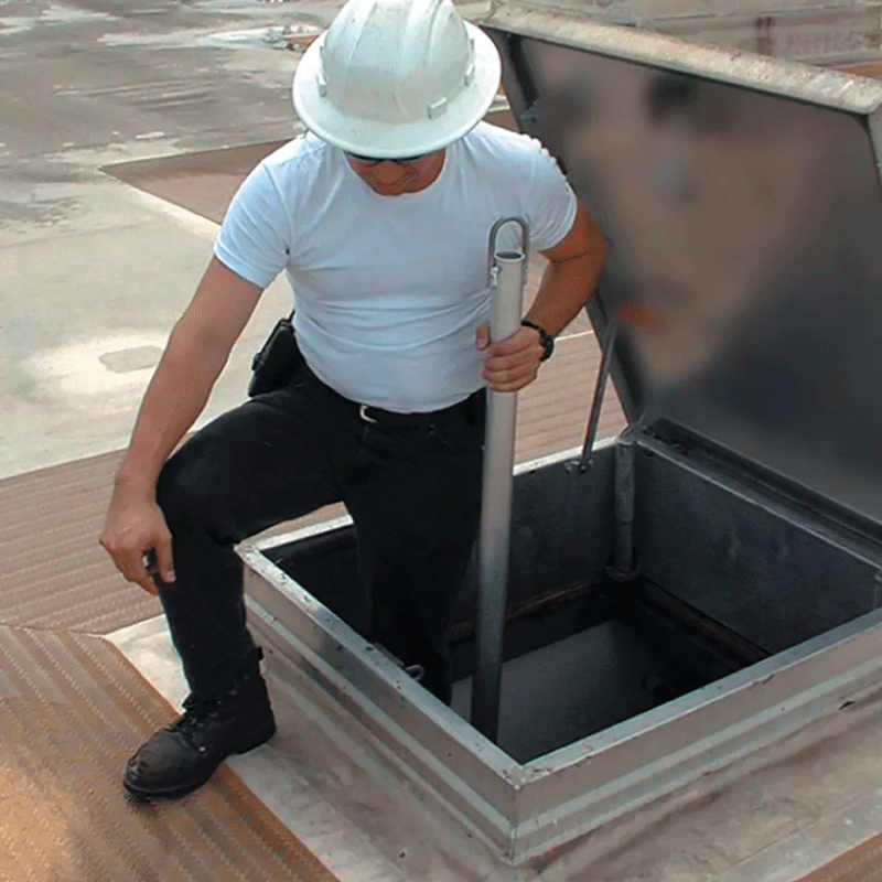 Exiting a roof hatch with a telescoping safety post for safely exiting a roof hatch or equipment hatch