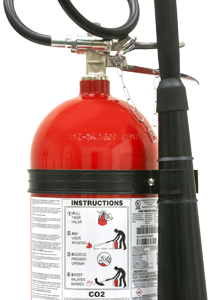 Red fire extinguisher with a long black hose and nozzle, label showing instructions and CO2 markings visible on the body.